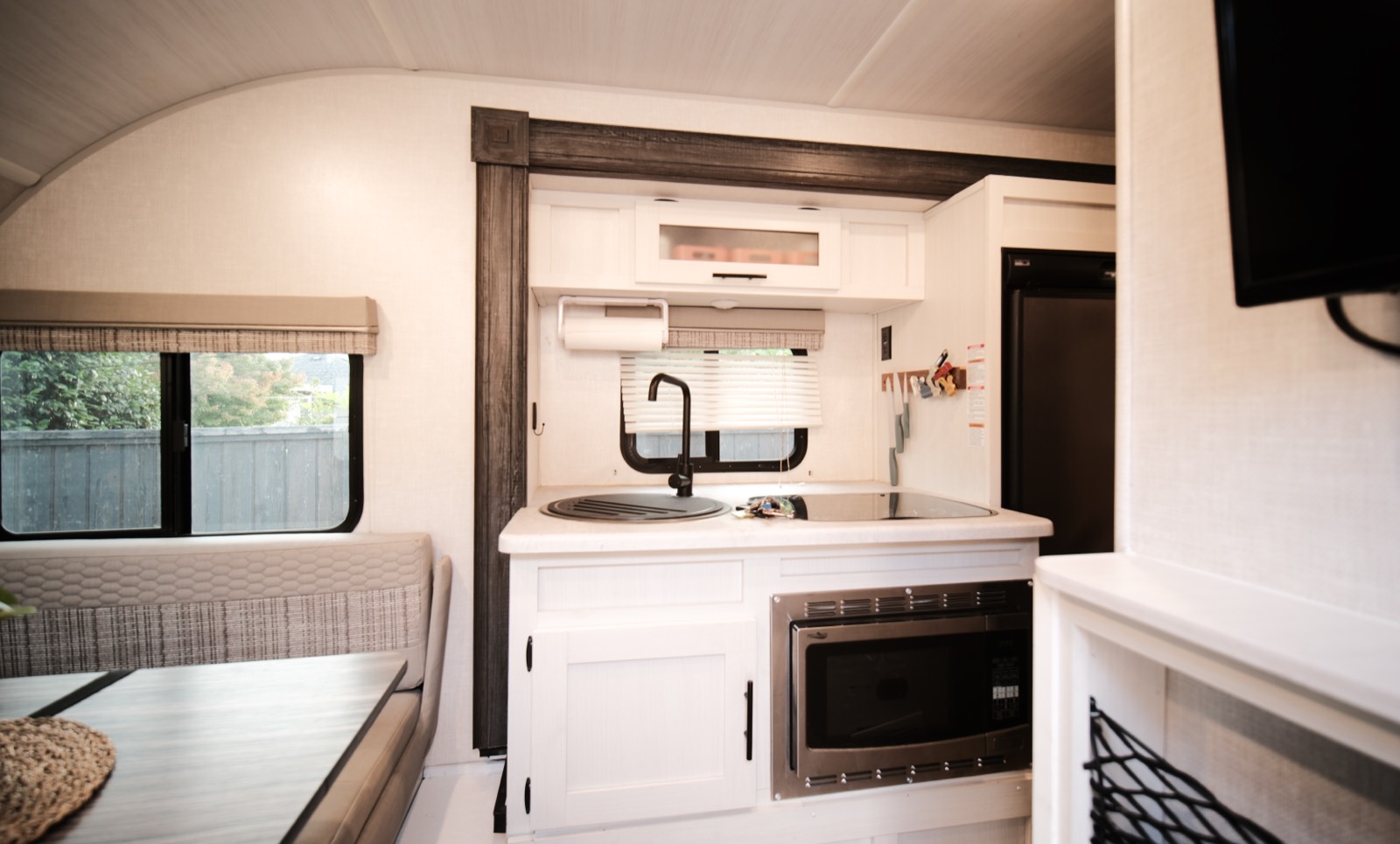 Kitchen with sink, two-burner induction cooktop and a microwave